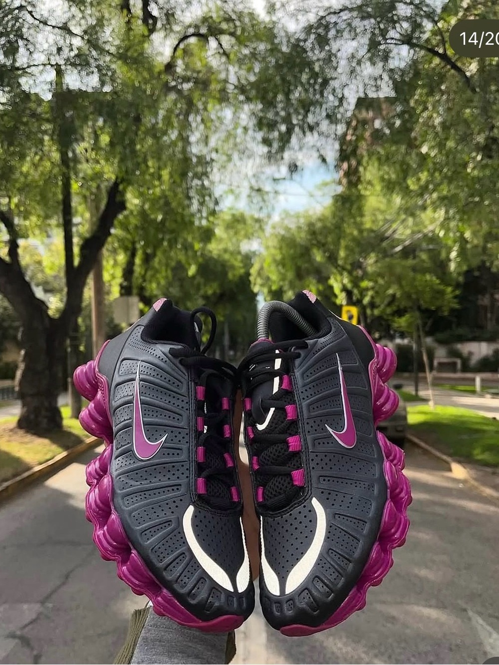 Woman’s Nike Shox TL sneakers in a black and hyper pink colorway.